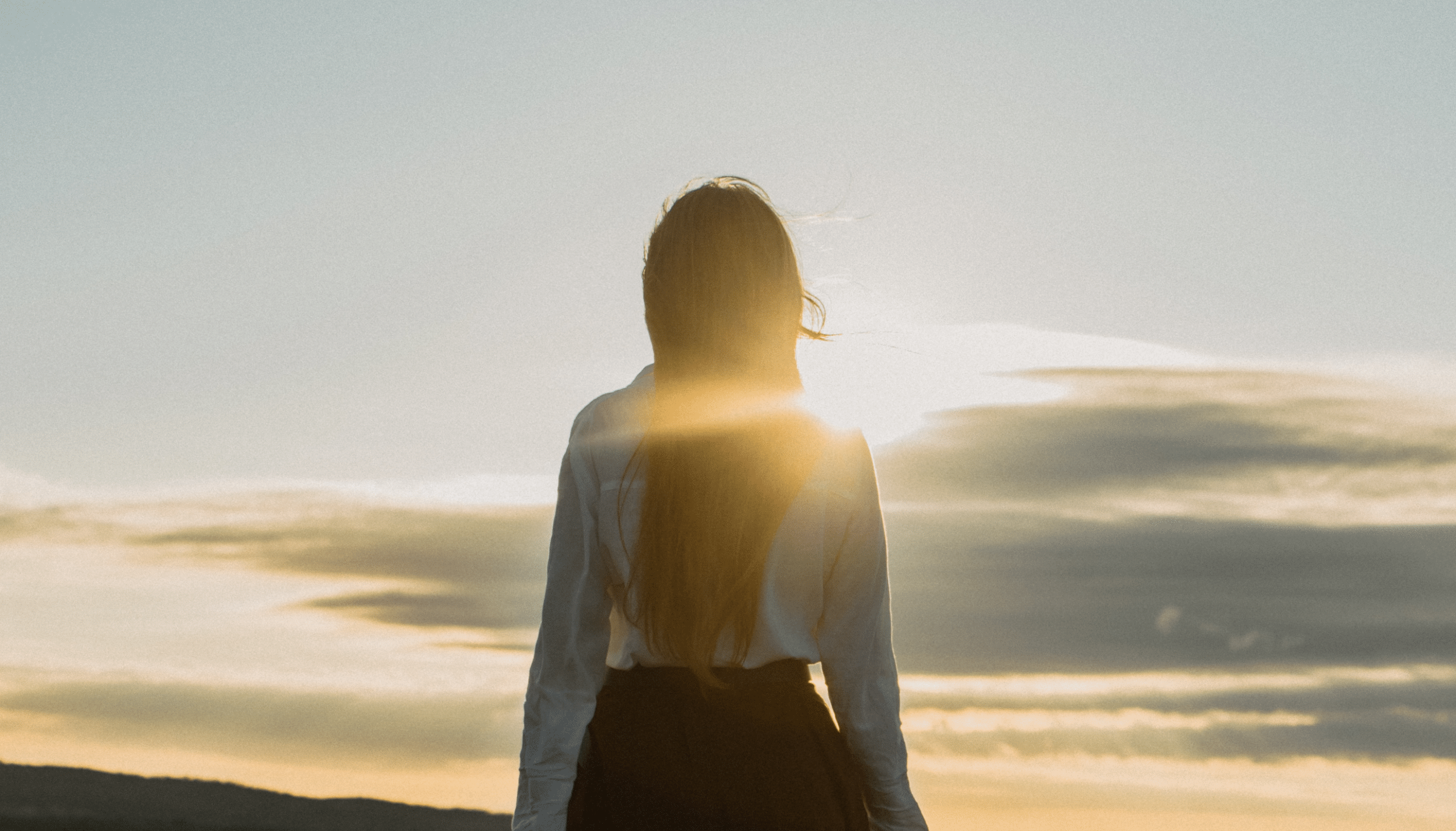 A woman watching sundown